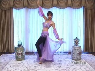Shamira in pink costume practicing bellydance moves 